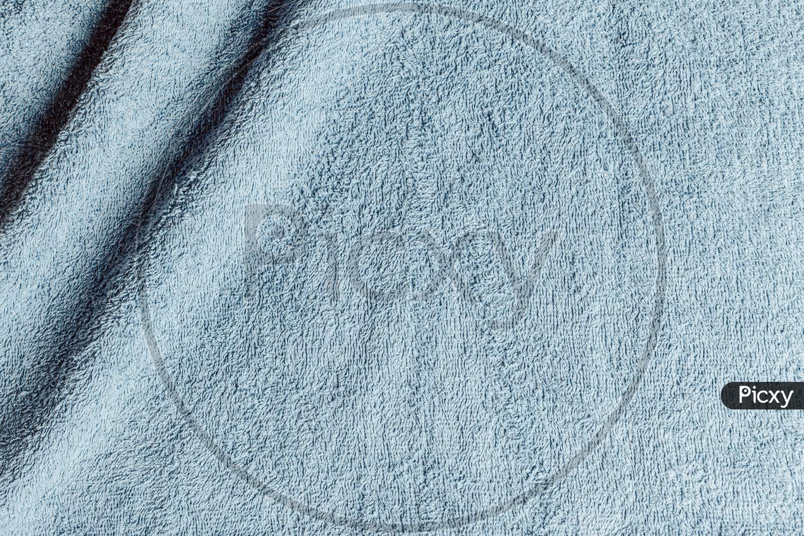 Top View From The Top Of A Light Blue Towel With Two Wrinkles