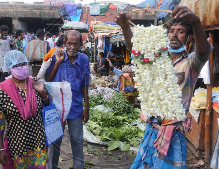 People throng the Mullik Ghat Flower Market flower market in Kolkata, August 12, 2020.