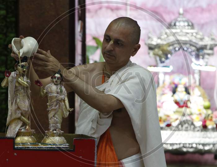 A devotee performs rituals during Janmashtami celebrations at a ISKCON  (The International Society for Krishna Consciousness) temple in Chandigarh August 12, 2020