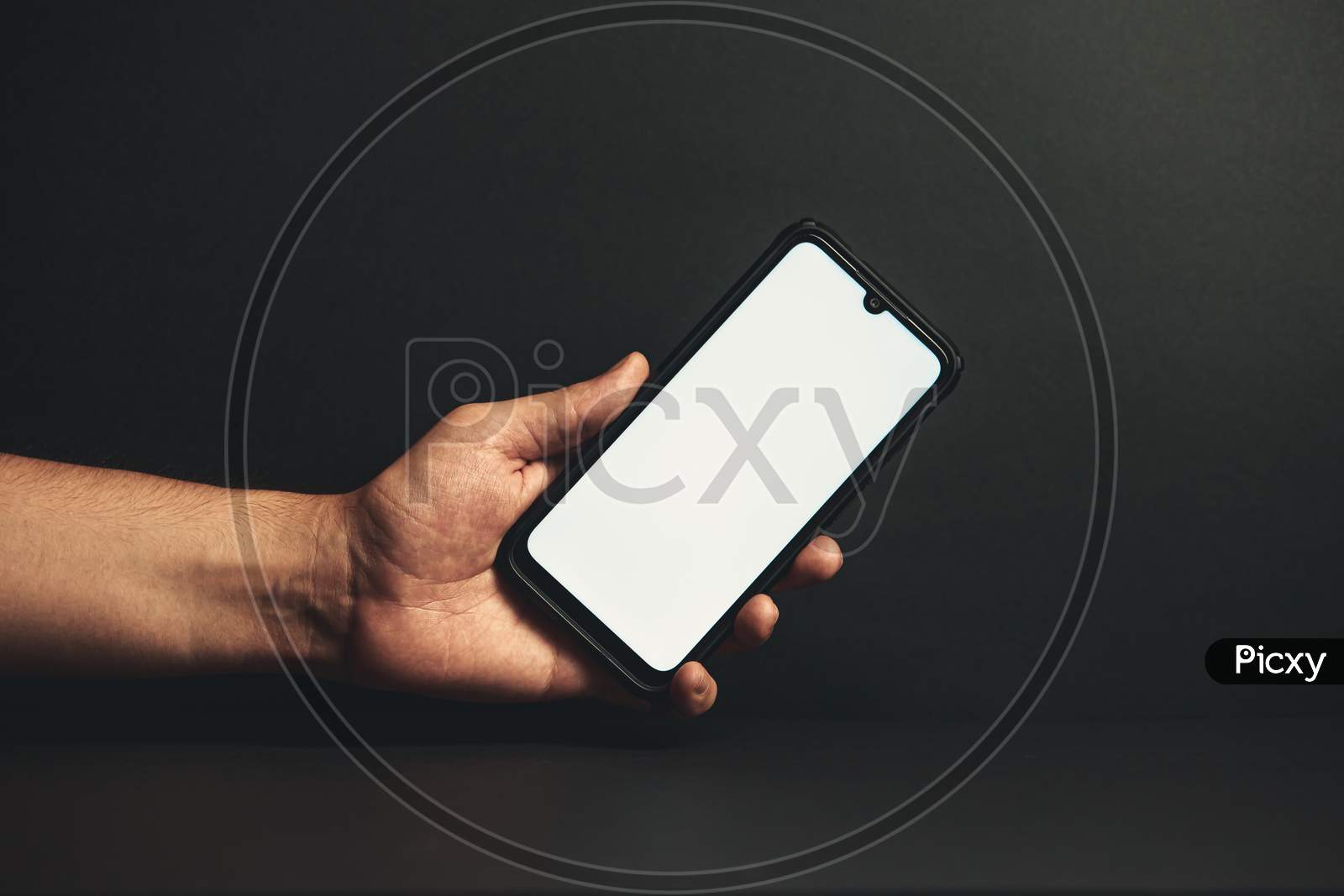 Young Hand Holding A Phone With A White Screen
