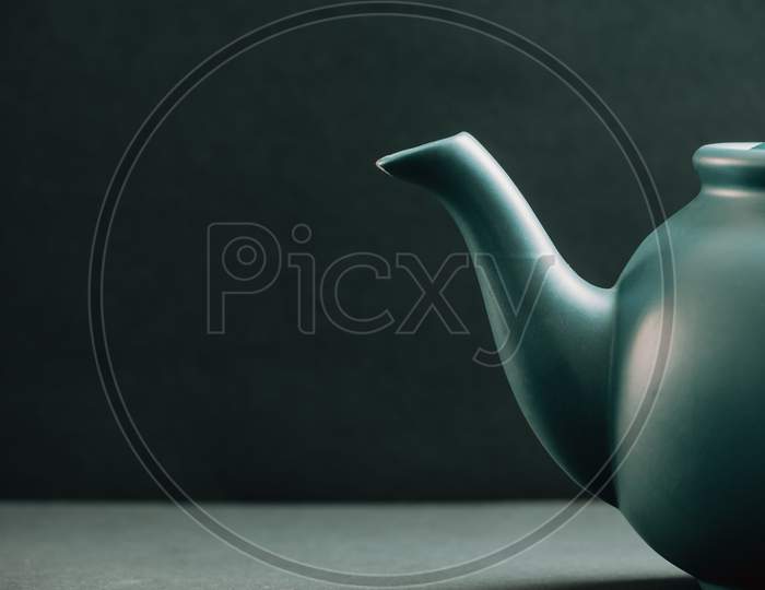 Teapot Showing From The Right Corner Over A Dark Background