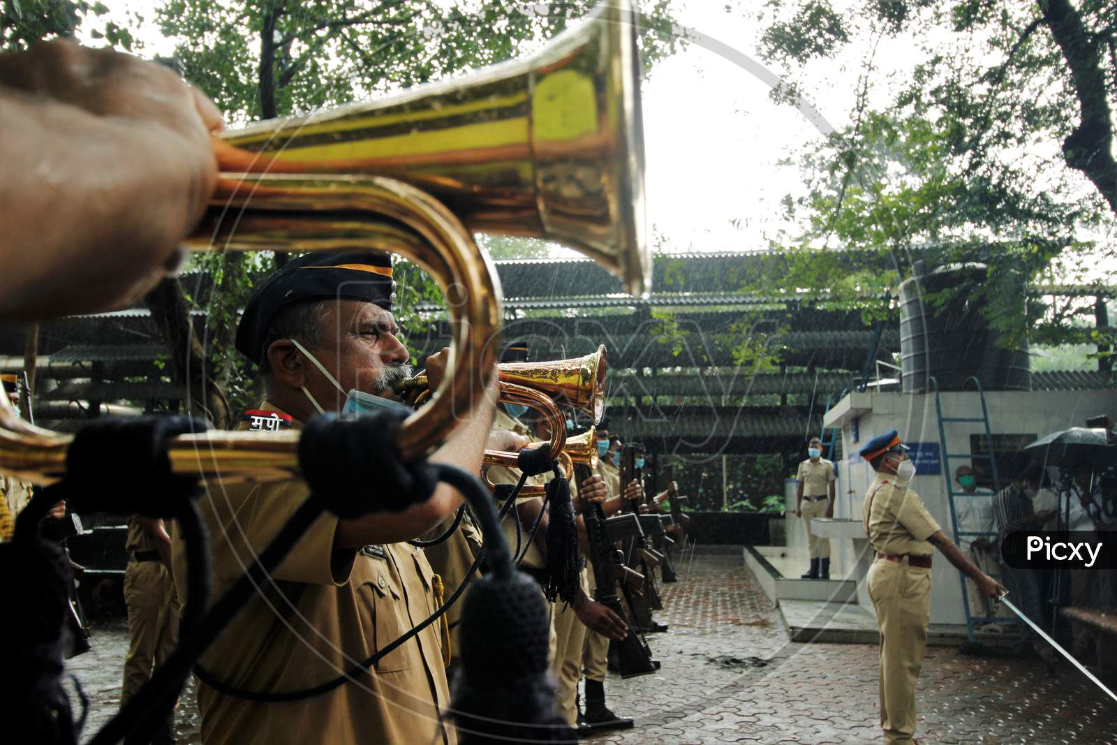 Police personnel pay tribute to deceased Air India pilot Deepak Sathe during his funeral in Mumbai, India on August 11, 2020.