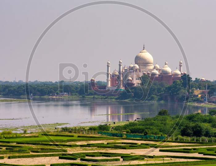 Distant View Of The Taj Mahal Mausoleum Next To The Yamuna River In, Agra, India