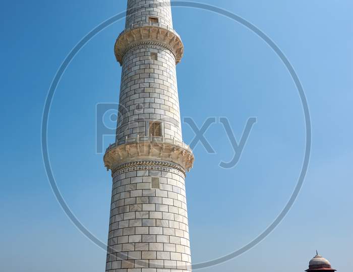 White Marble Minaret Of The Taj Mahal Mausoleum In Agra, Uttar Pradesh, India