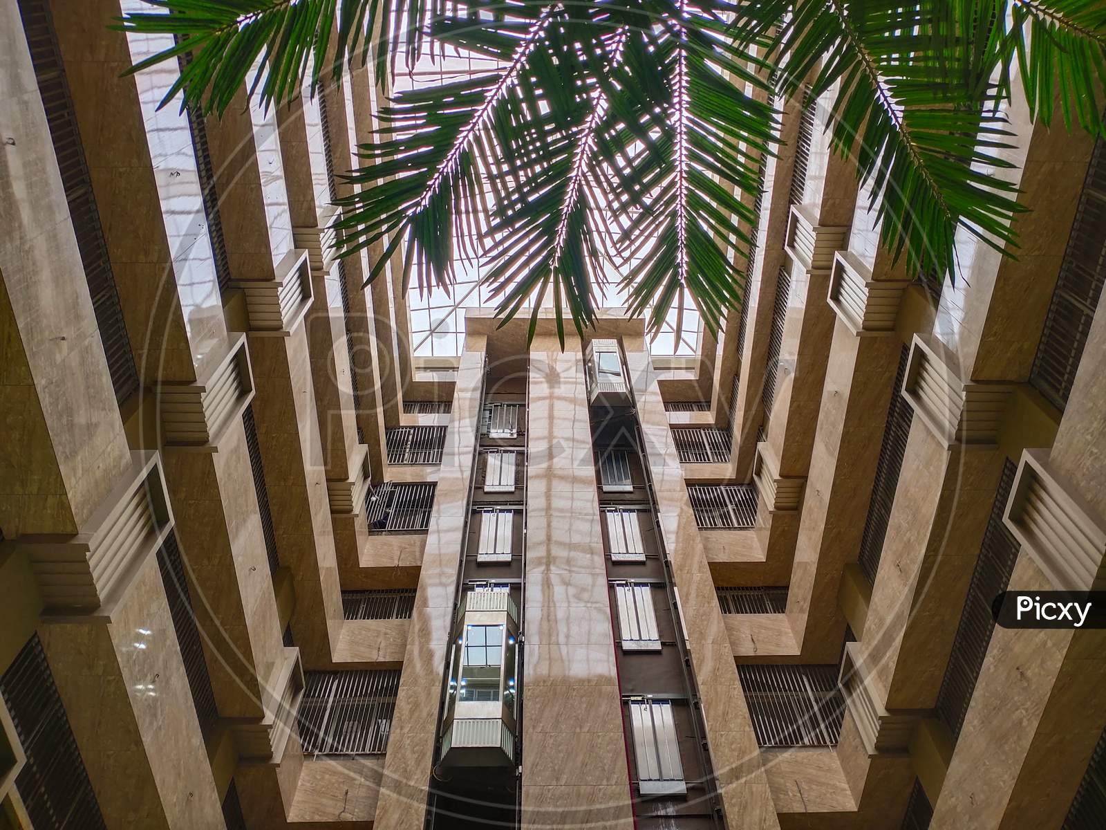 Symmetrical corridor of building and glass elevator exterior