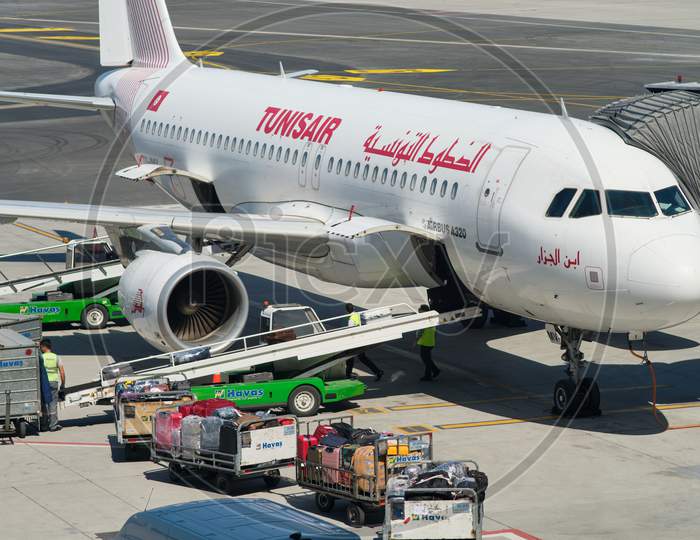 Airport Workers Loading The Luggage Bags Into A Tunisair Airbus A320 At The New Istanbul Airport, Istanbul Havalimani In Turkey