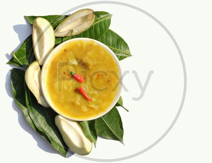 Mango Chutney Or Cuisine In A Plate With Raw Mango And Leaves Isolated On White Background With Copy Space