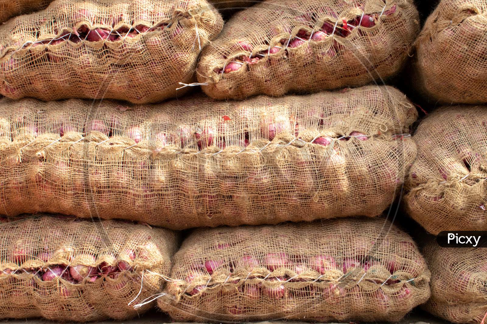 Onion Sacks In An Indian Vegetable Market For Selling And Exporting