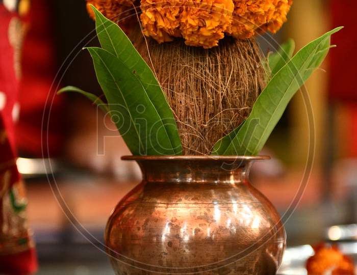 Copper Kalash With Coconut And Mango Leaf With Floral Decoration. Essential In Hindu Puja.