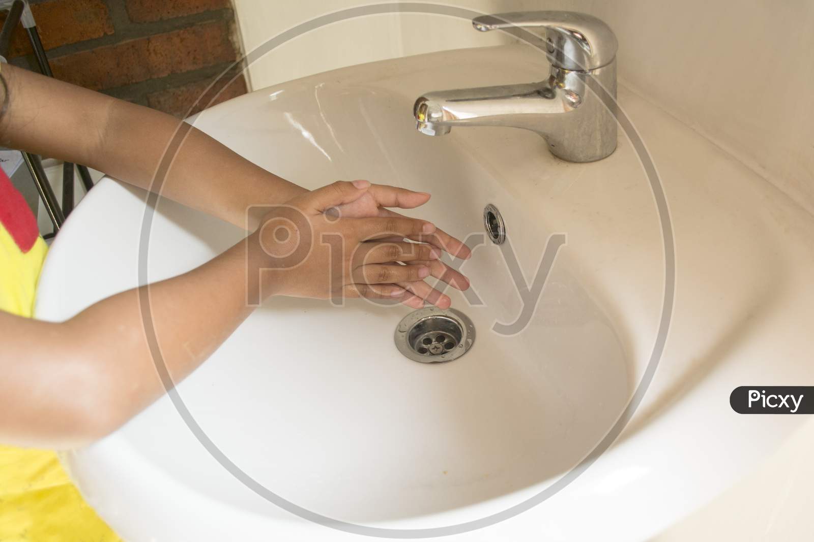Little Girl'S Hands Dry Before Washing Hands In The Sink