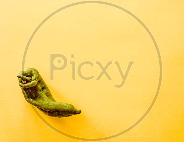 A Top View Of A Pepper Over A Yellow Background