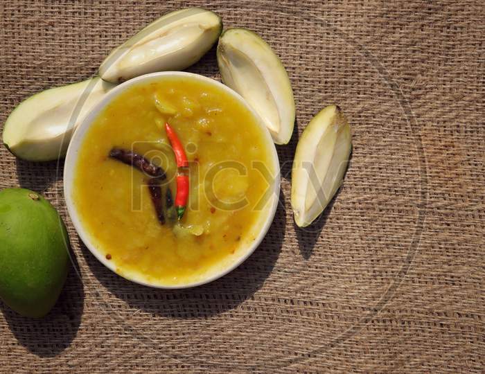 Mango Chutney Cuisine In Plate With Raw Mango On Burlap Background With Copy Space For Texts Writing