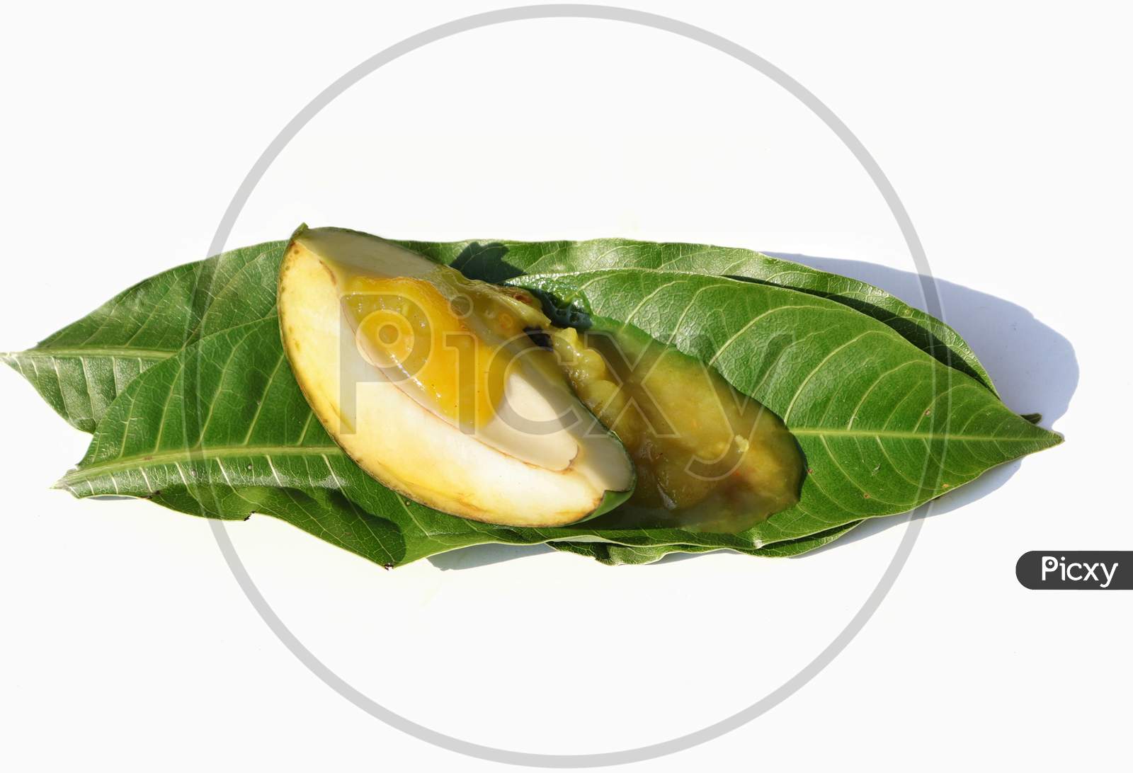 Mango Chutney With Raw Mango Cut On Leaves Isolated On White Background
