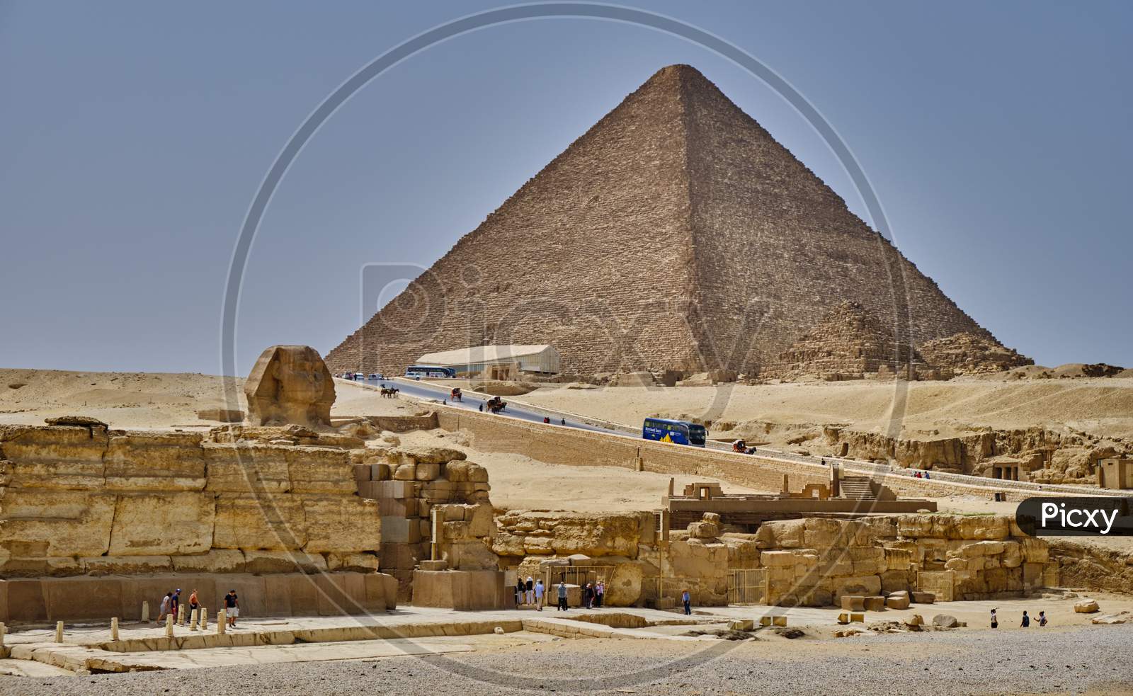 Tourists Visiting The Giza Plateau With The Great Sphinx And The Giza Pyramid Complex In Cairo, Egypt