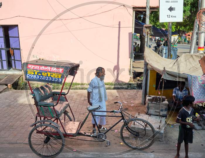 Poor Old Rickshaw Driver With His Bicycle Rickshaw In Agra, Uttar Pradesh, India
