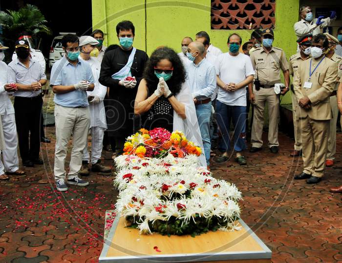 Wife of deceased Air India pilot Deepak Sathe pays him respect during his funeral in Mumbai, India on August 11, 2020.