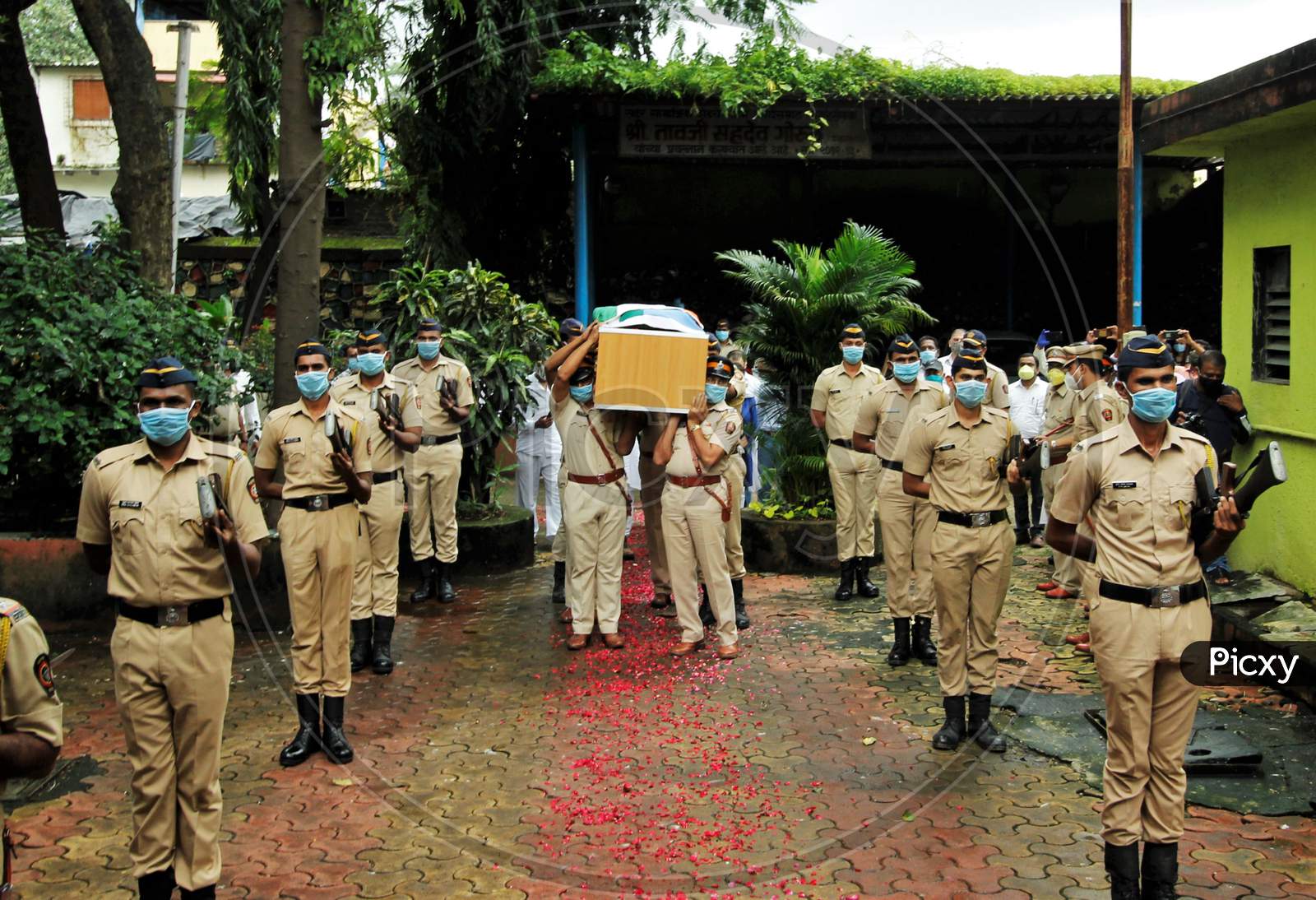Police personnel carry the coffin of deceased Air India pilot Deepak Sathe, during his funeral in Mumbai, India on August 11, 2020.