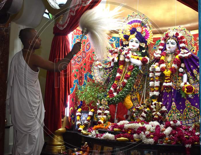 Hindu priest offers prayers to Lord Krishna and Radha on the occasion of Krishna Janmashtami festival at ISKCON temple  in Prayagraj, August 12, 2020.