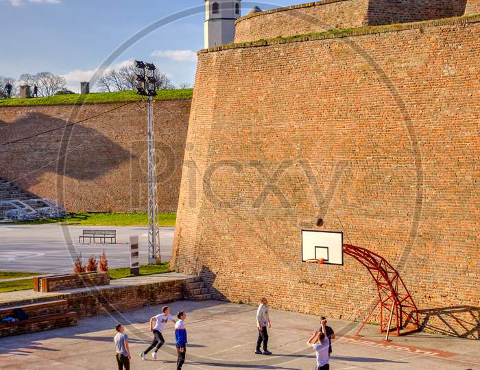Teenagers Playing Basketball At Basketball Court In Belgrade Fortress In Serbia