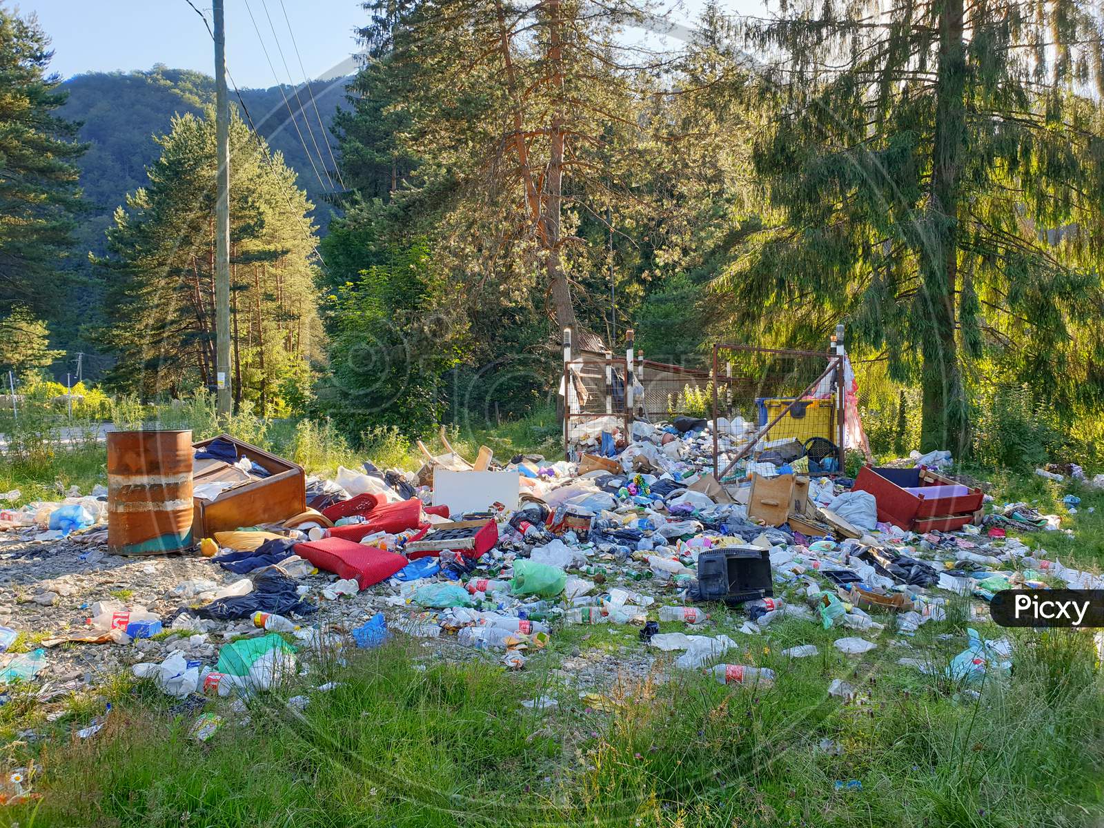 Filled Trash Bins Outdoors In Mountain Area