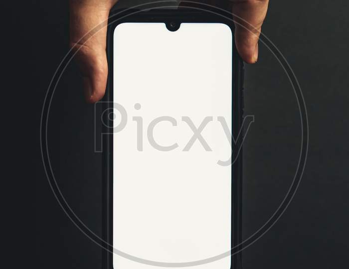 Hand Grabbing A Phone From The Top With Copy Space