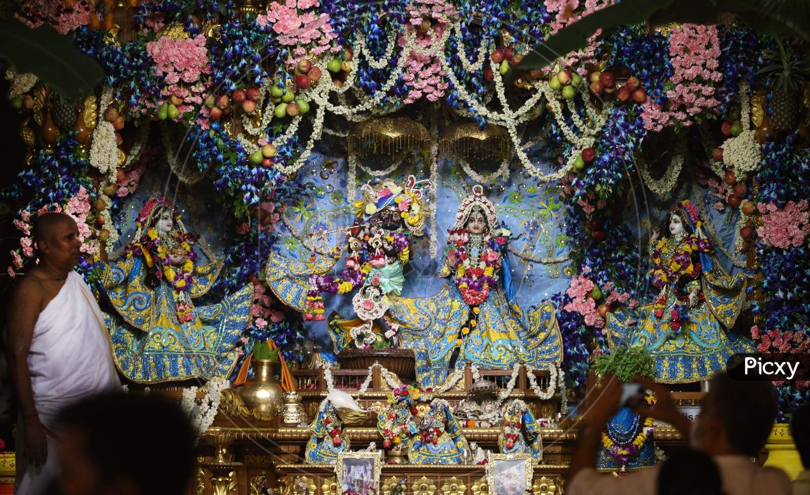 A Priest Performs 'Aarti' Of Radha - Krishna On The Occasion Of Sri Krishna Janmashtami At ISKCON Temple In New Delhi On August 12, 2020.