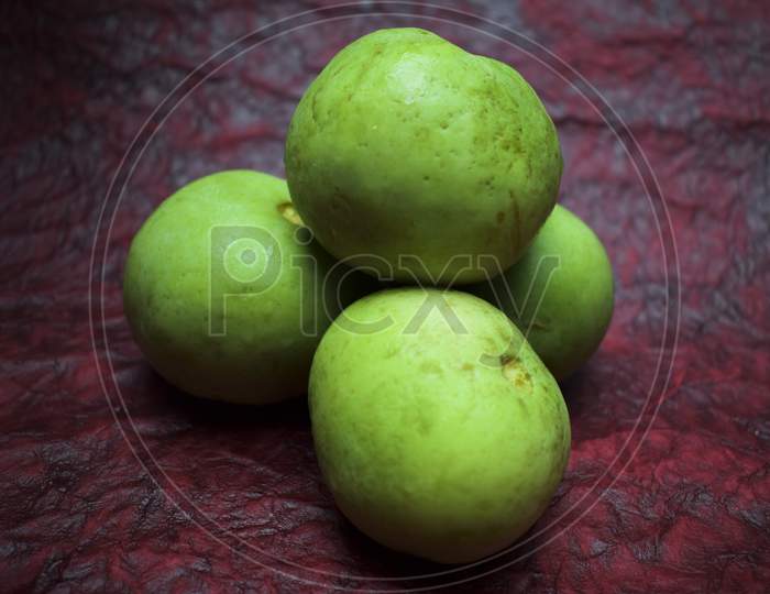 Round Melon, Indian Squash Or Indian Round Gourd Also Known As Tinda In India. Fresh Green Organic Indian And Pakistani Vegetable On Red Background