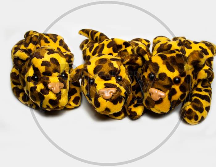 Three Stuffed Leopard Soft Toys Isolated On A Plain White Background