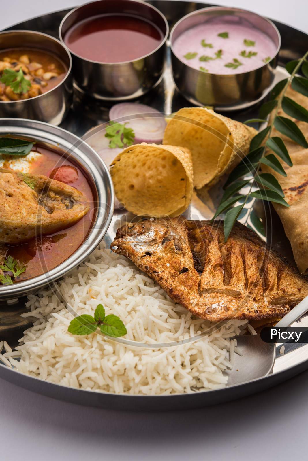 Indian Fish Platter Or Seafood Thali Served In A Steel Plate Or Over Banana Leaf