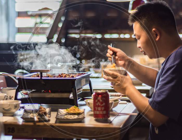 Man Enjoying Local Xian Chinese Cuisine In Xian, China