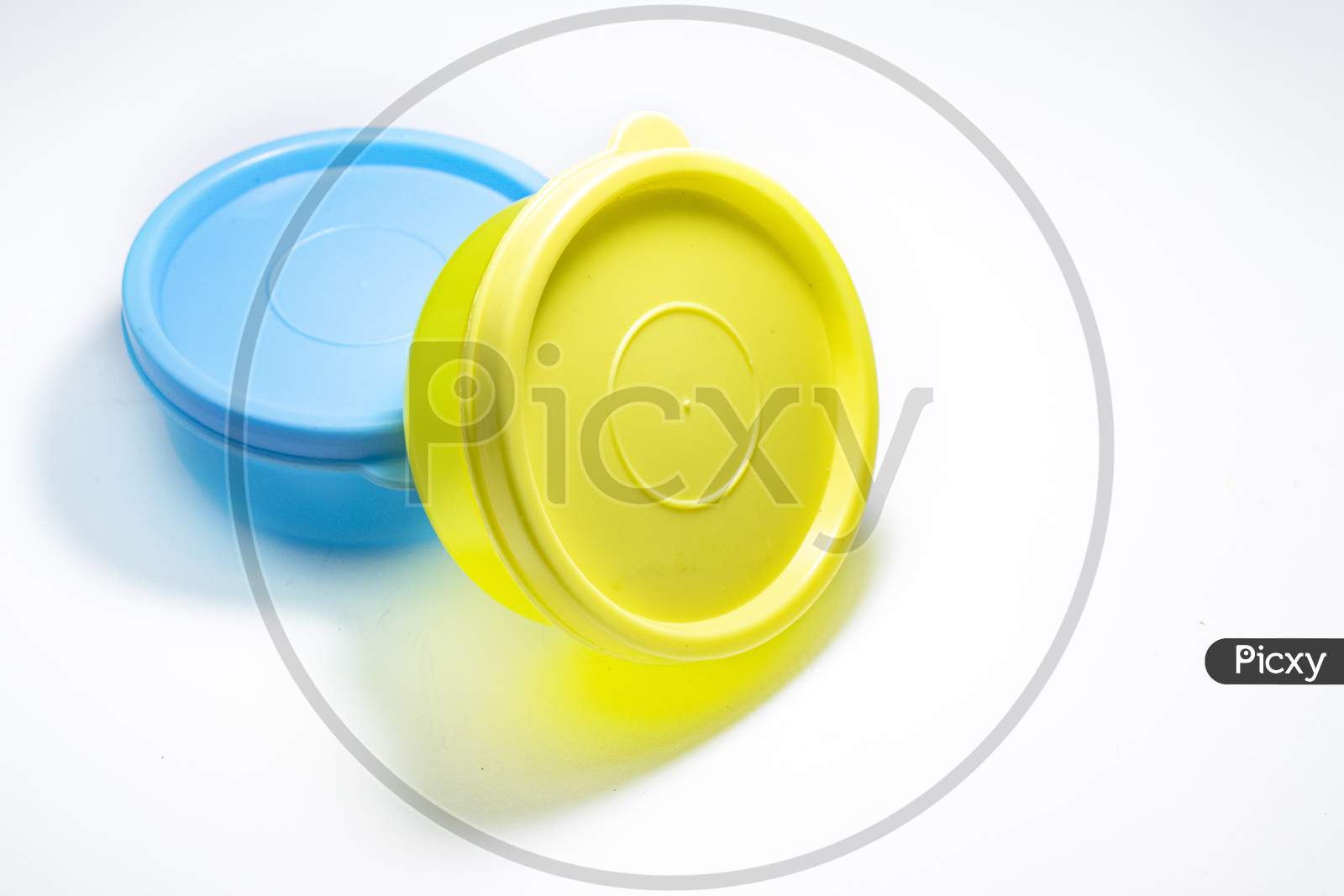 One Yellow And One Blue Container On White Background.