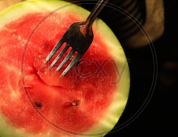 Half Sliced Watermelon With Fork