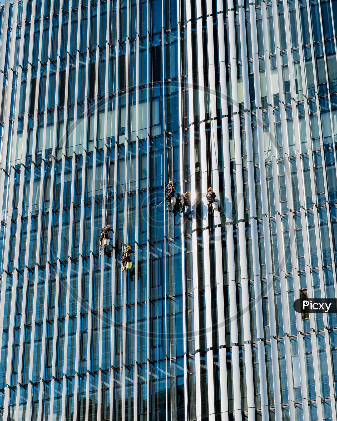 Workers Cleaning Windows Of A Skyscraper In Beijing, China
