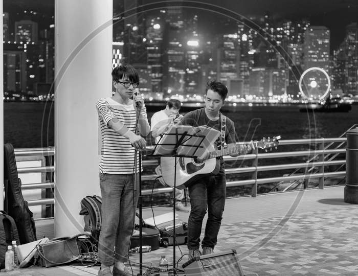 Street Musicians Performing In Tsim Sha Tsui Promenade Of Kowloon, Hong Kong
