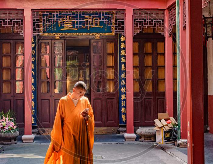 Monk In Jingan Buddhist Temple In Shanghai, China