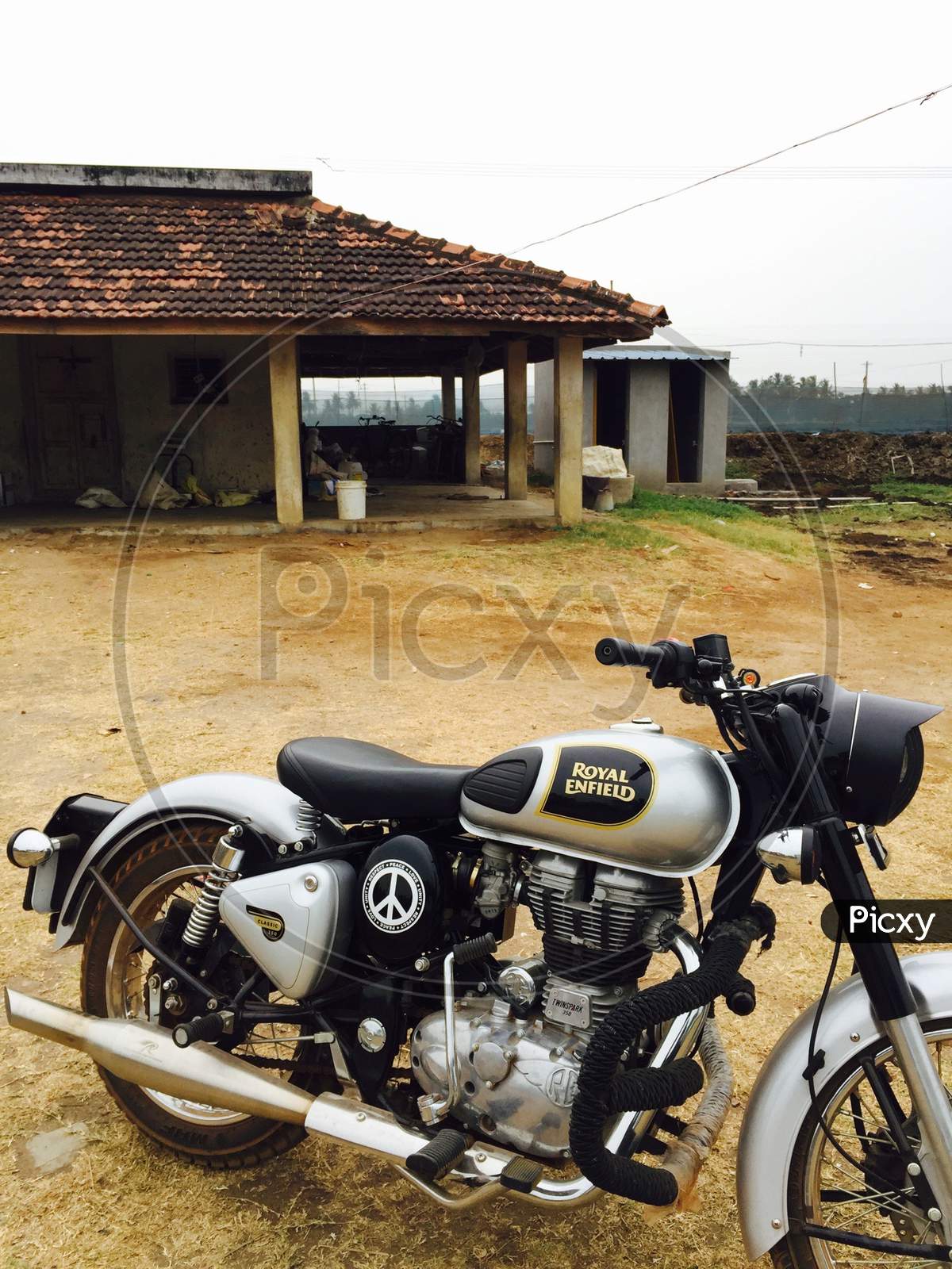 An Indian single seater bike Royal Enfield at an farm