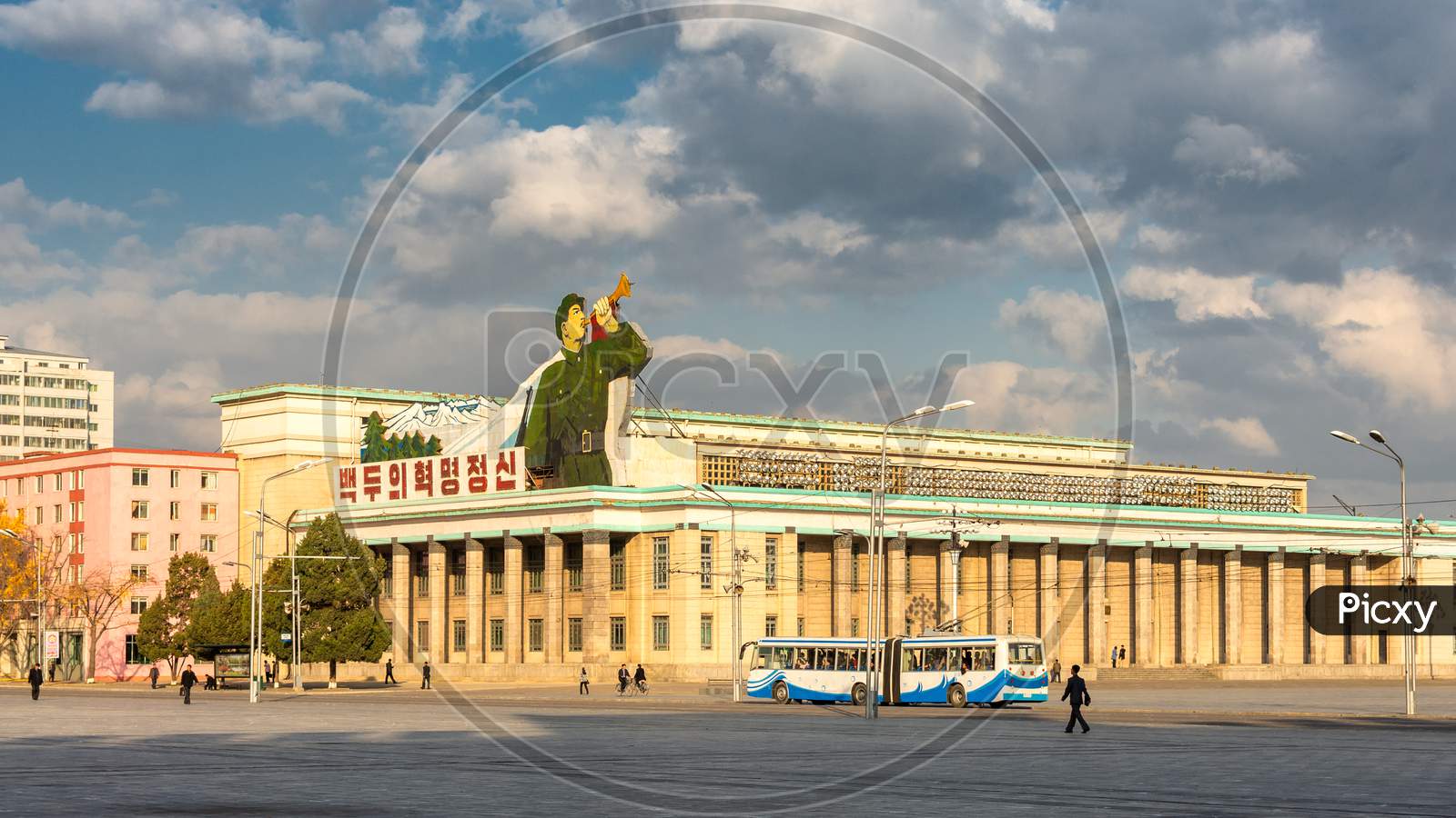 Kim Il-Sung Square And Government Buildings Decorated With Flags And Revolutionary Slogans In Pyongyang, North Korea