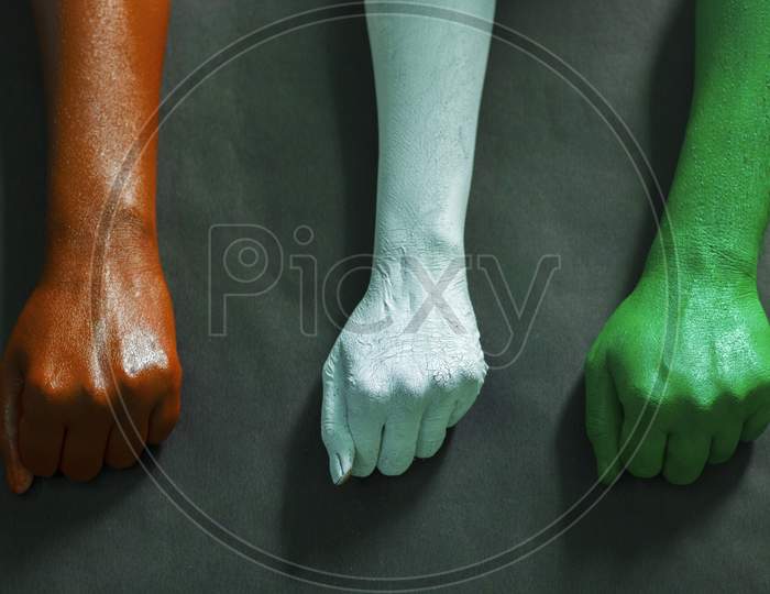 three hands are painted with three colors,saffron,white and green to represent tricolor Indian national flag.15 August Independence day India.celebration of freedom.symbol of brotherhood.