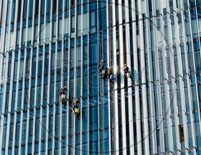 Workers Cleaning Windows Of A Skyscraper In Beijing, China