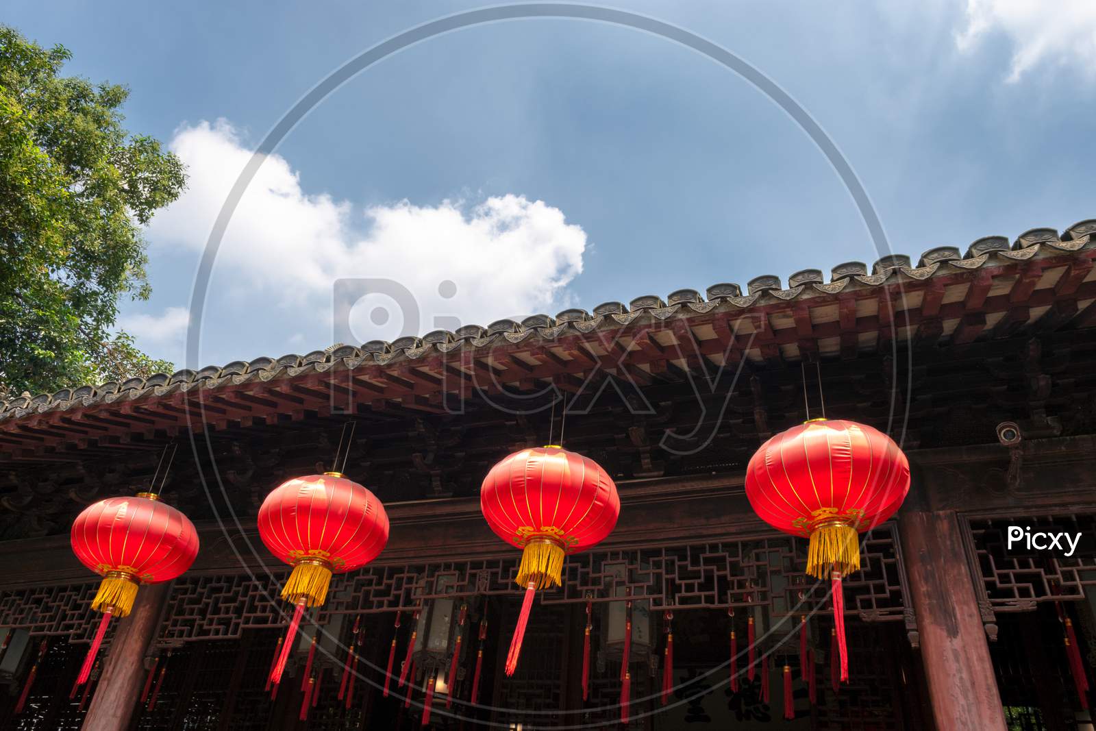 Red Lanterns, Symbols Of Vitality And Good Luck, Hanging From The Roof Of Old Traditional Style Chinese Residence