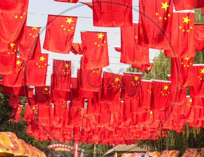 Flags Of The Peoples Republic Of China, Hanging In A Park In Beijing, China