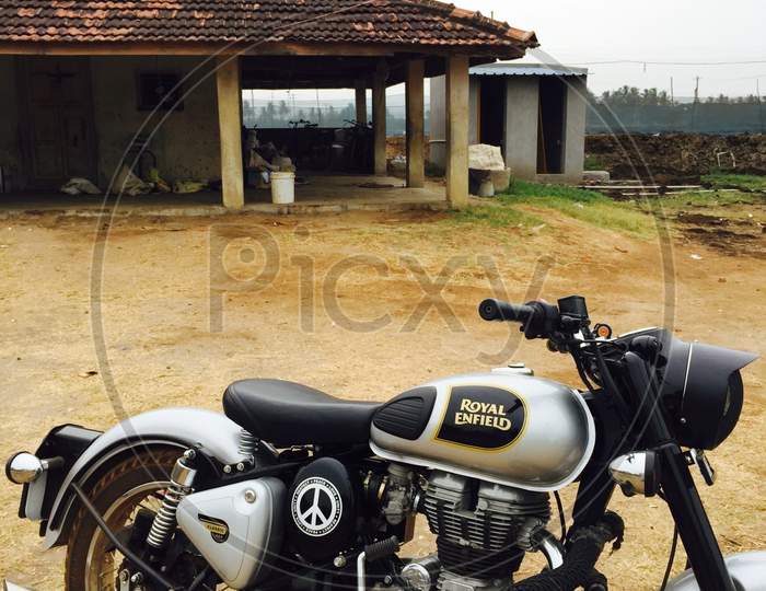 An Indian single seater bike Royal Enfield at an farm