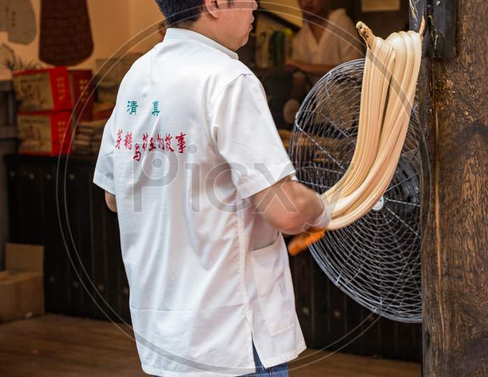 Man Preparing Noodles In Muslim Quarter Of The Old City Of Xian, China