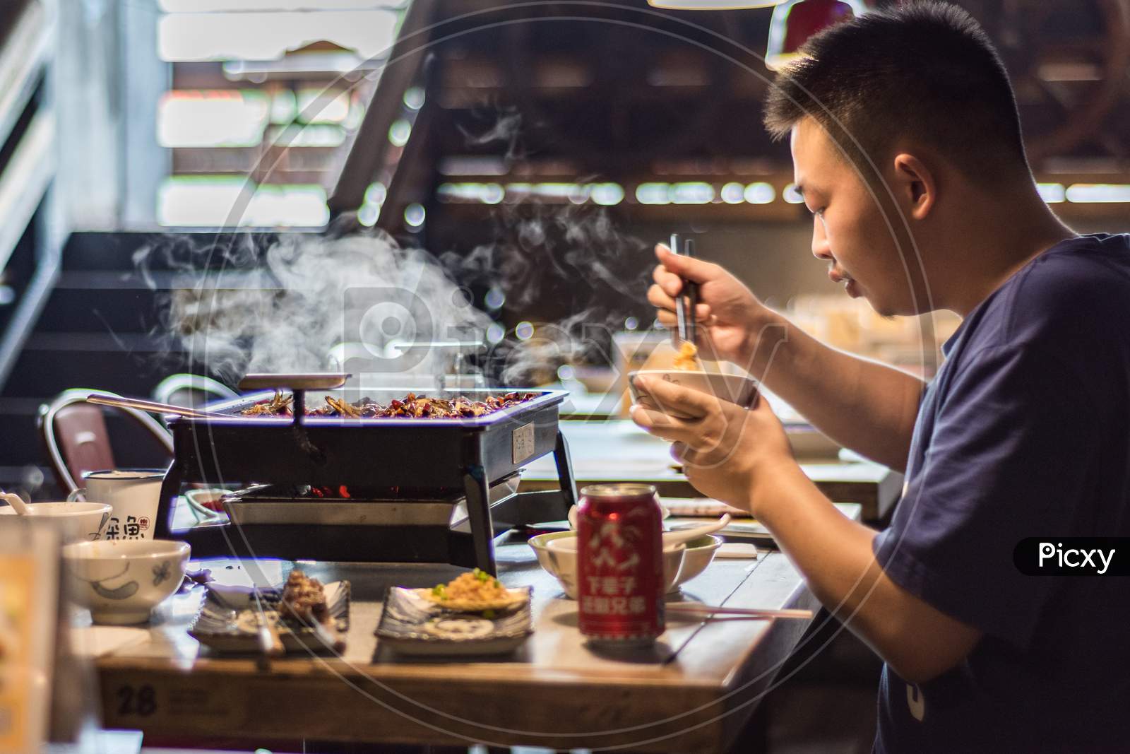 Man Enjoying Local Xian Chinese Cuisine In Xian, China