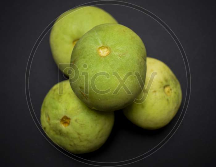 Round Melon, Indian Squash Or Indian Round Gourd Also Known As Tinda In India. Fresh Green Organic Vegetable On Black Background