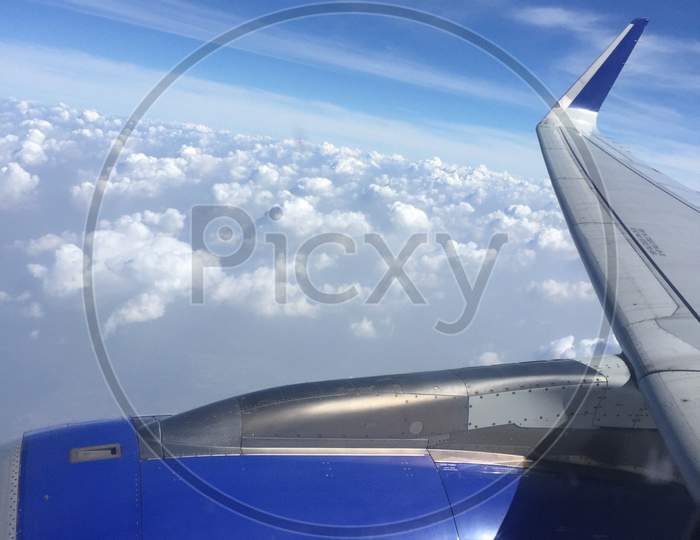 A view of sky and clouds from a plane window