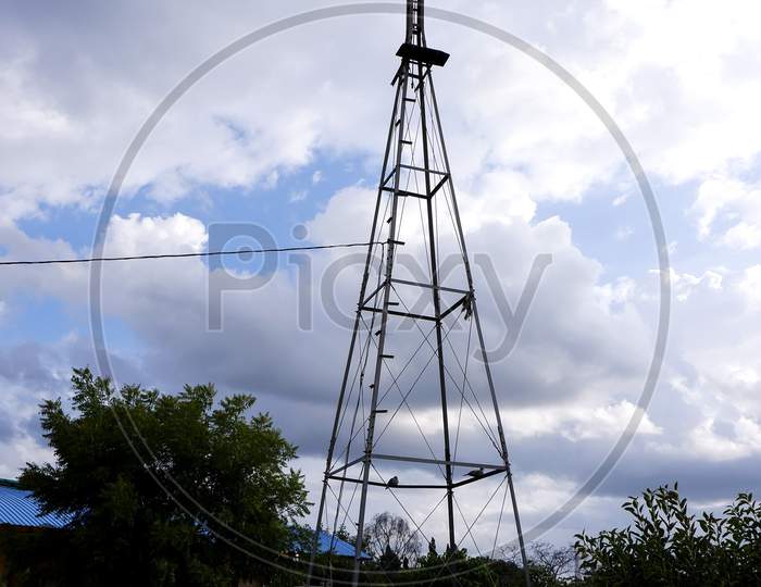 Long View Of Weather Vane Metal Tower Isolated In Outdoor