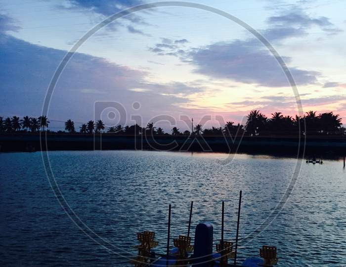 Sunset and blue sky with water and Areator and aquaculture form