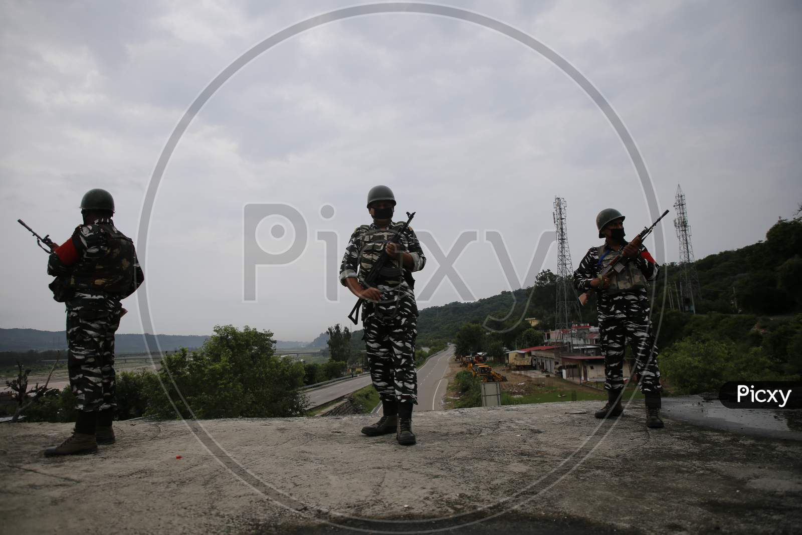 CRPF personnel stand guard along the Jammu-Srinagar highway near Jammu, ahead of the 74th Independence day celebrations  in Jammu on August 14, 2020.