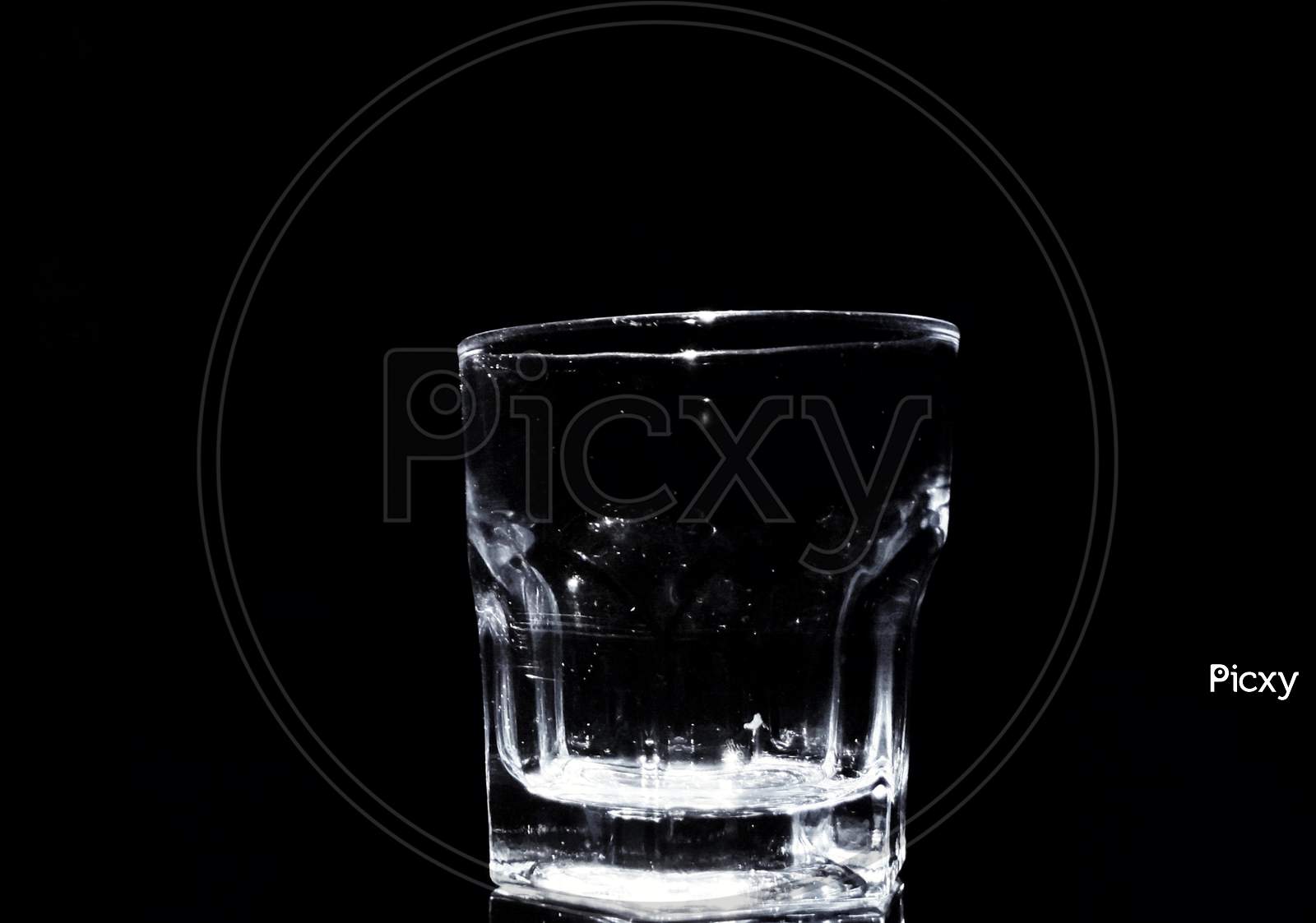 Whiskey glass with a black background